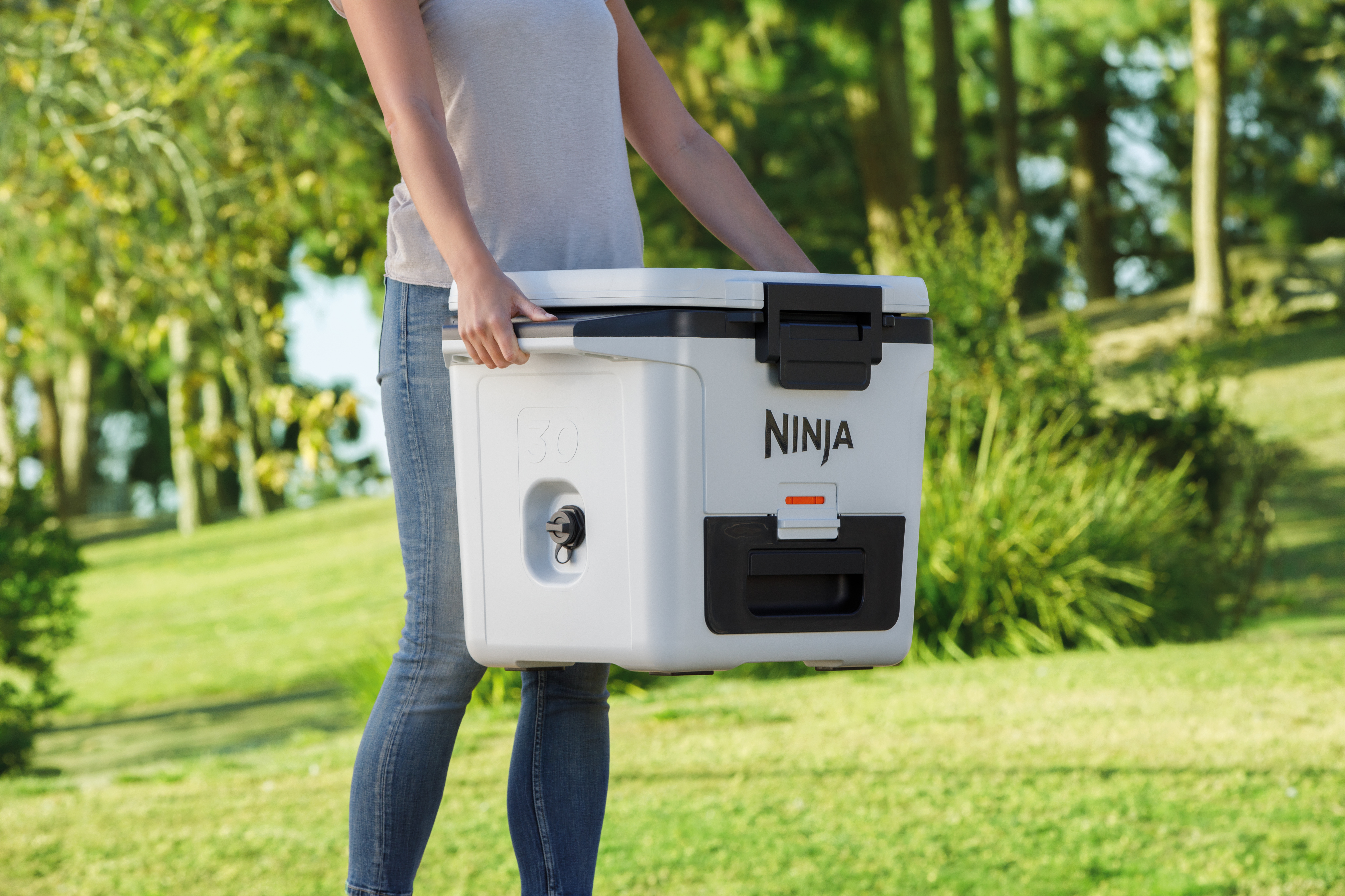 Ninja-FB131WH_InUse_Park_Carrying_Cooler_Woman - Image 5