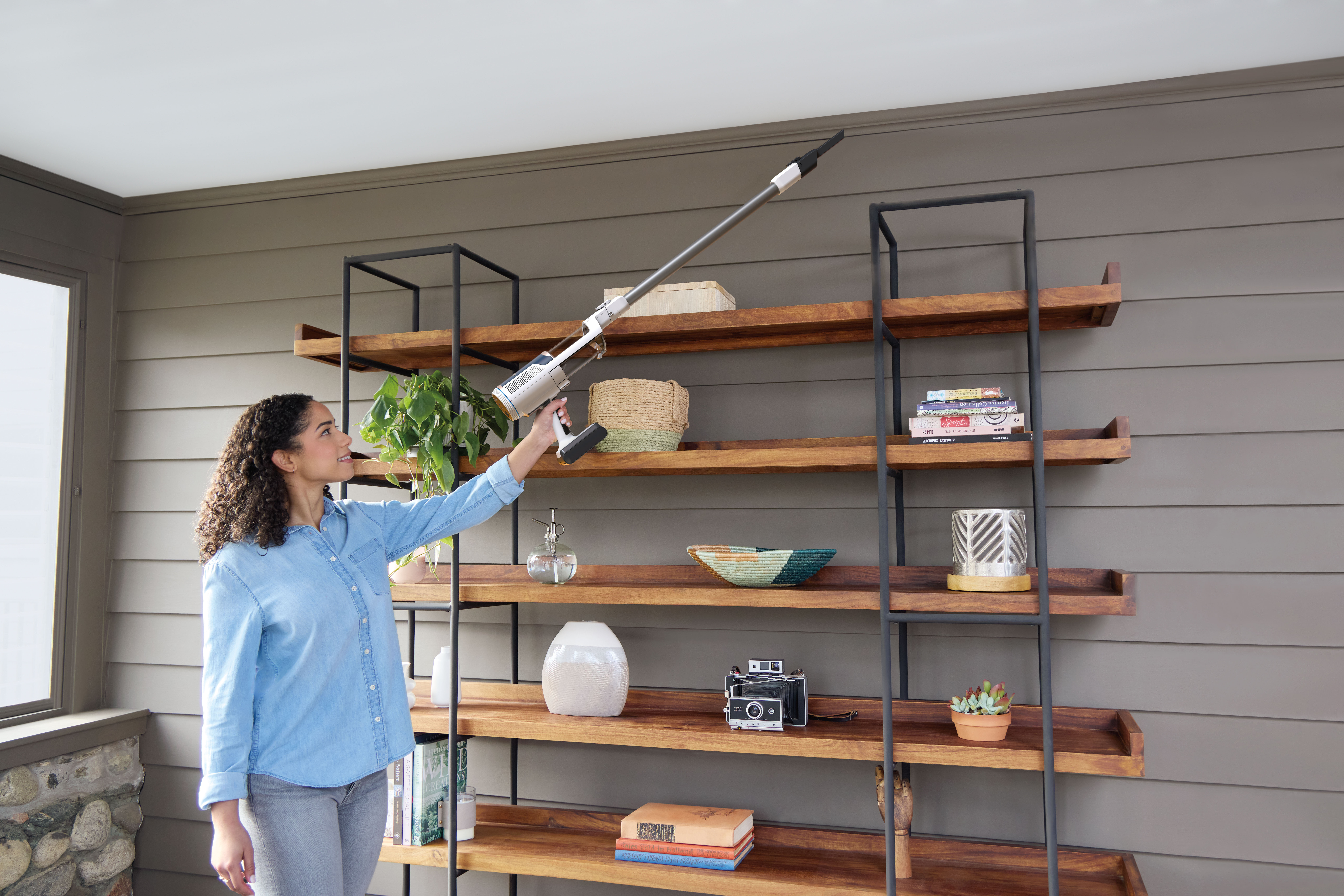 Shark-BU3521UK-InUse-LivingRoom-Bookshelf-Reach-DusterCreviceTool-Woman - Image 18