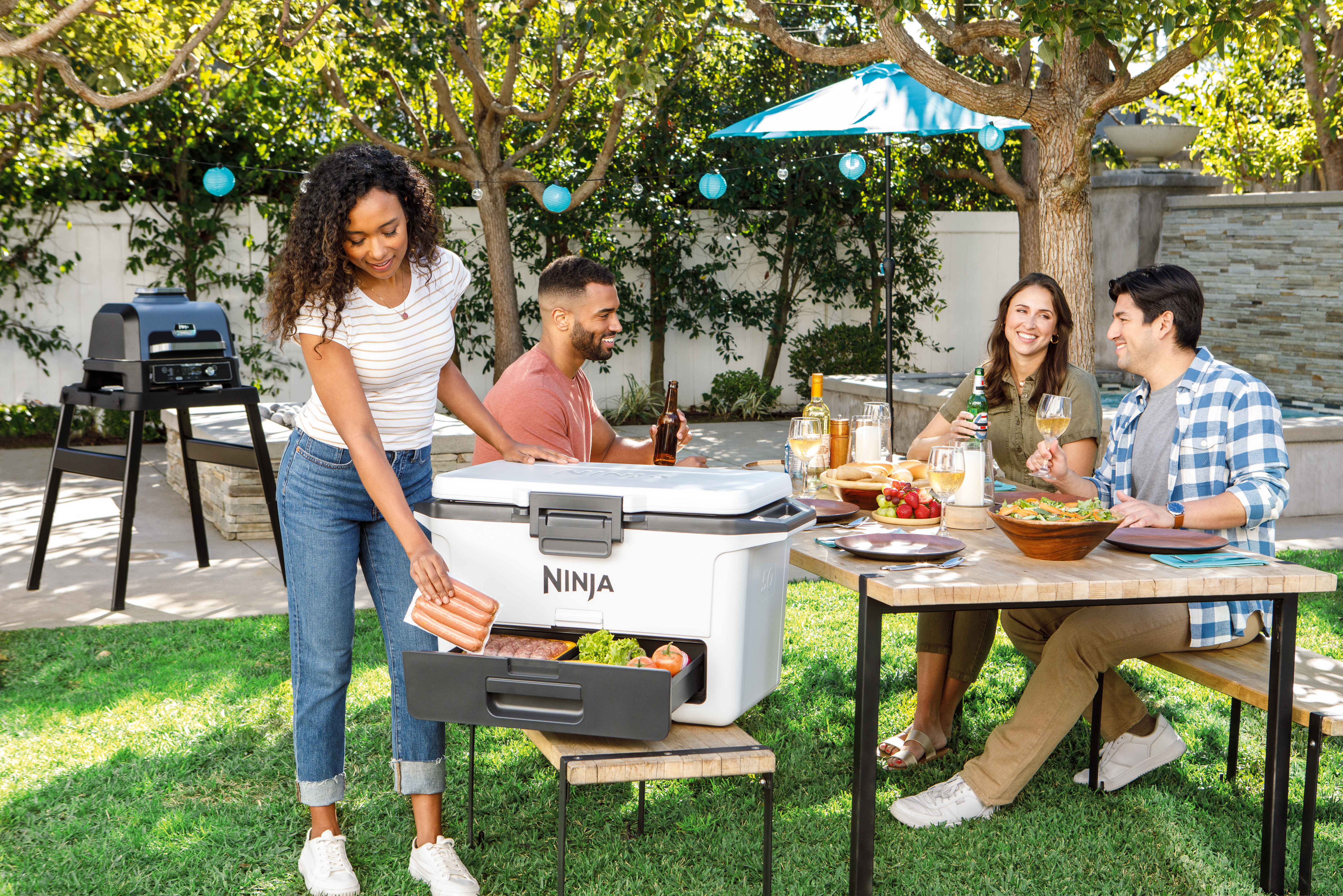 Ninja-FB151WH-InUse-BackYard-ServingFood-Group-Woman - Image 11