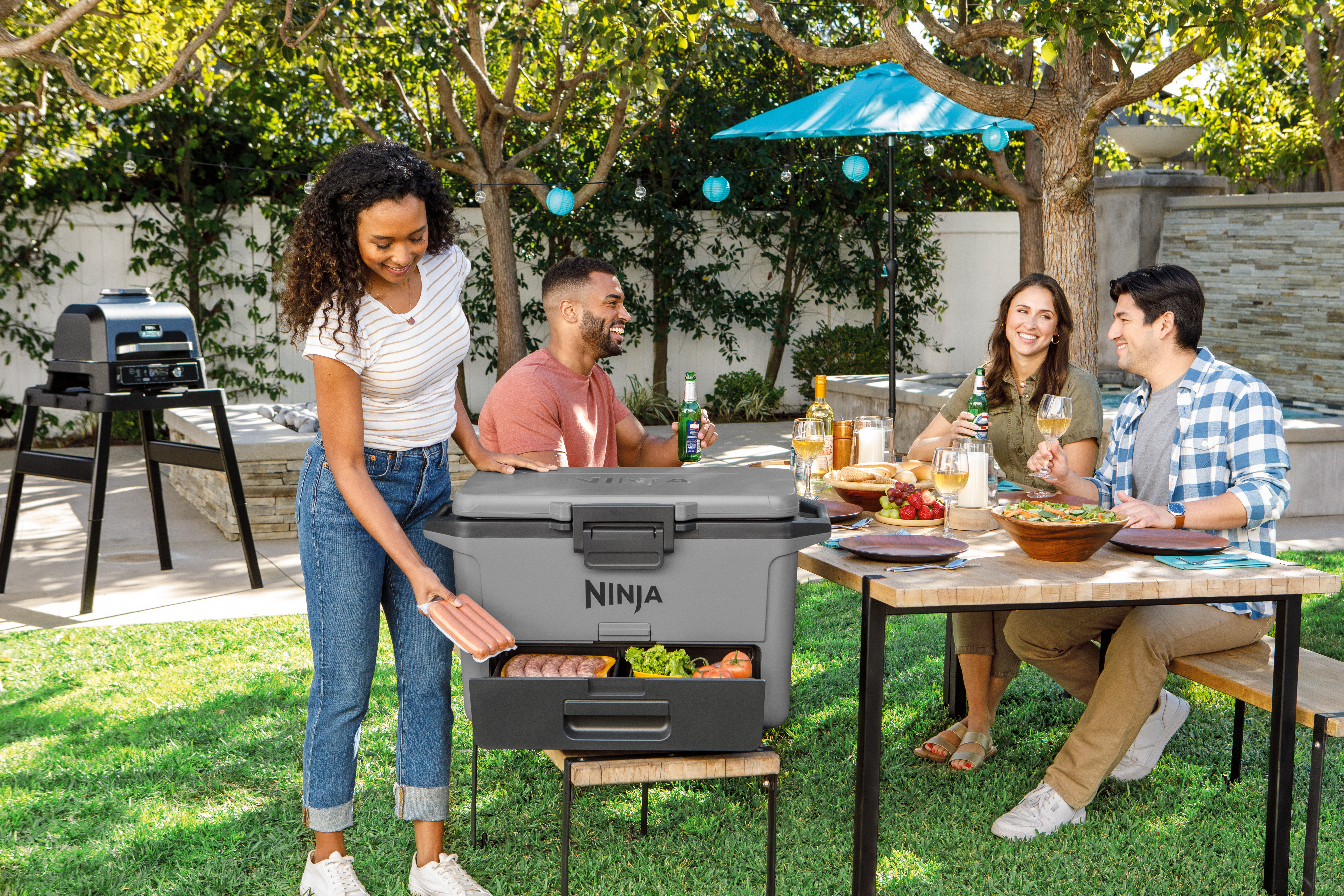Ninja-FB151GY-InUse-BackYard-ServingFood-Group-Woman - Image 11