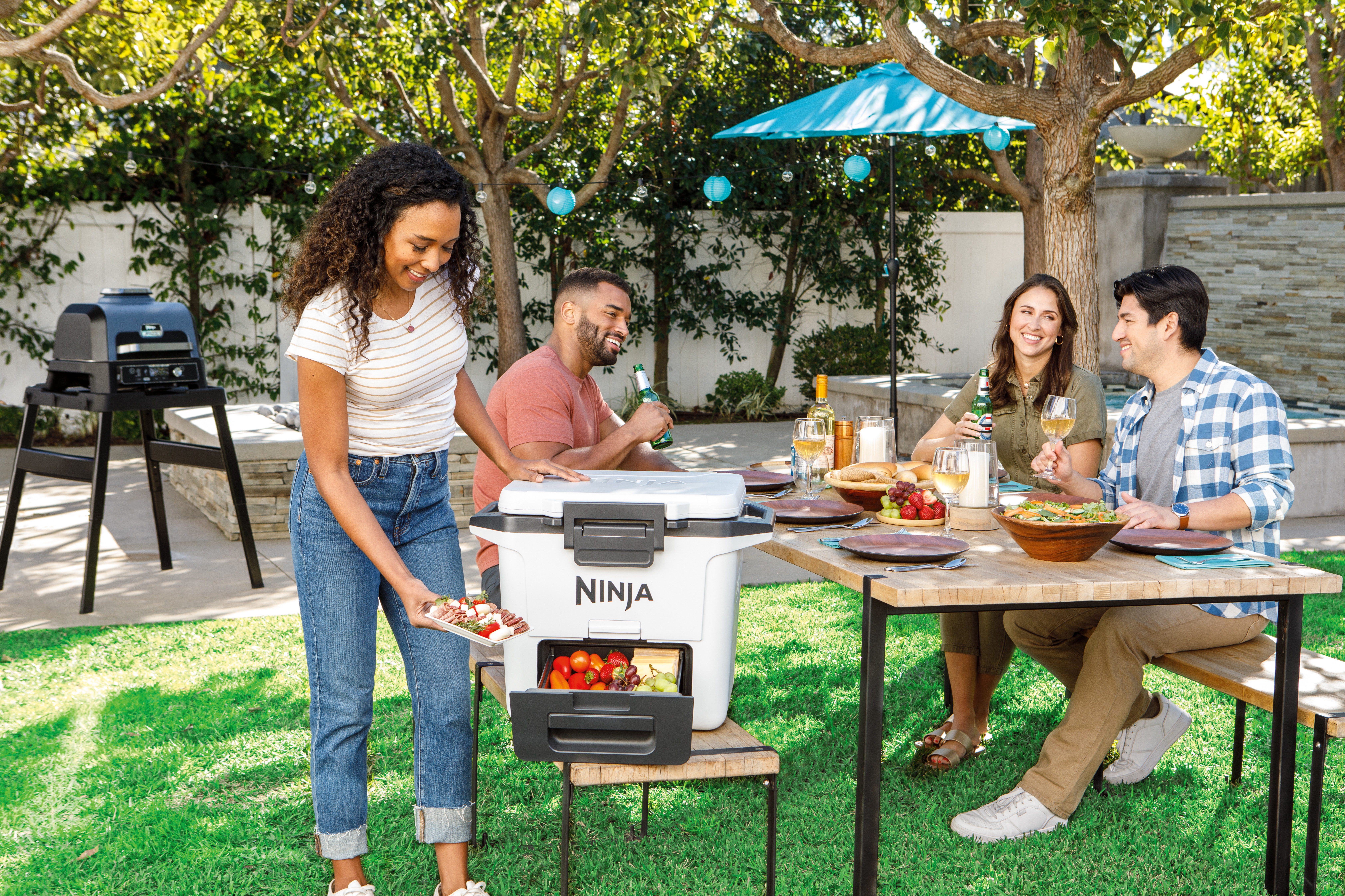 Ninja-FB131WH_InUse_BackYard_ServingFood_Group_Woman - Image 9